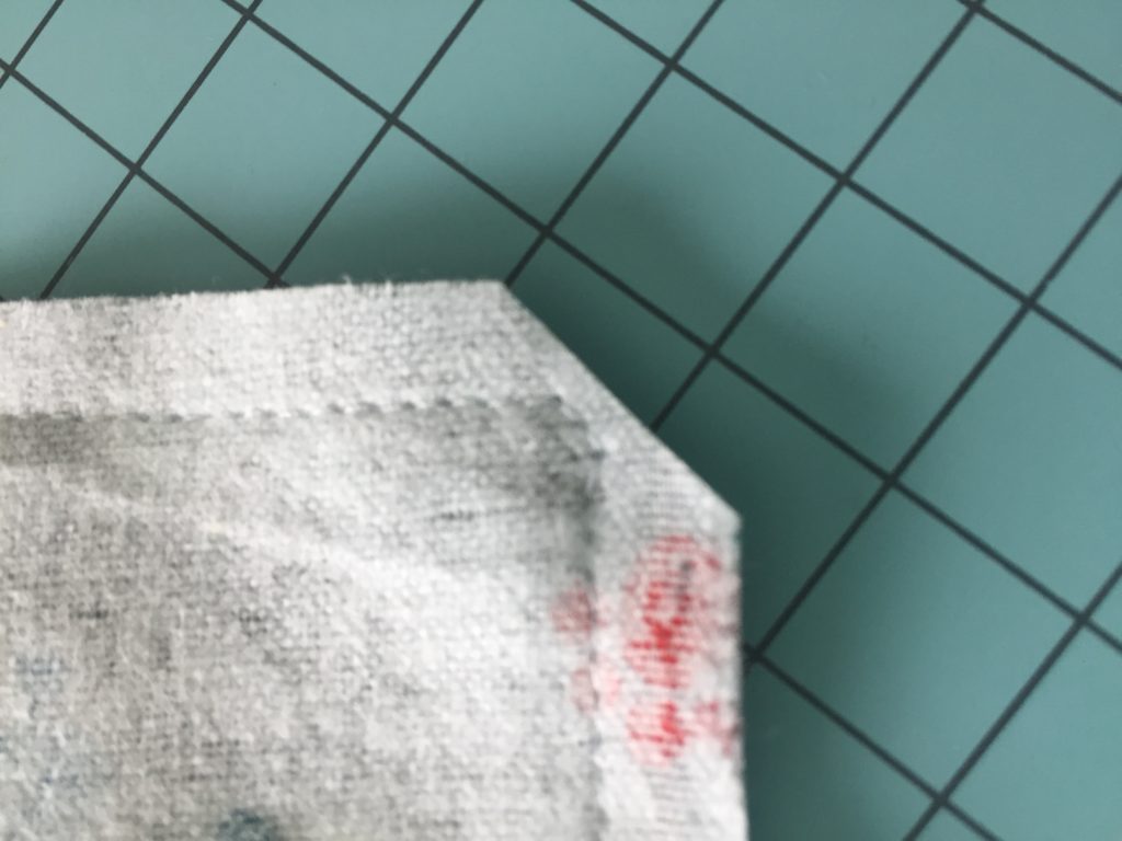 corner of burp cloth clipped on diagonal