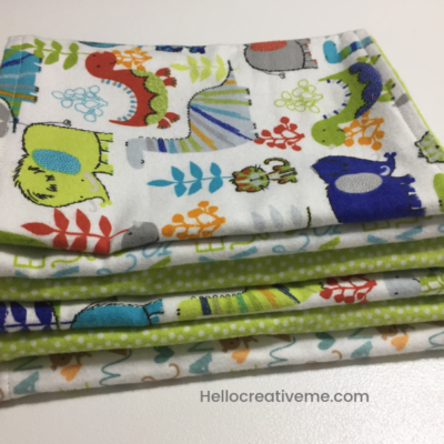 stack of white and green DIY baby burp cloths