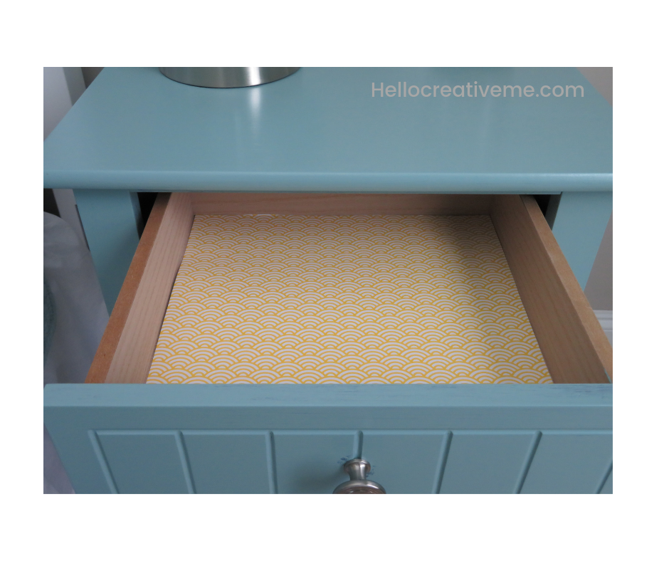 nightstand drawer lined with yellow decorative paper