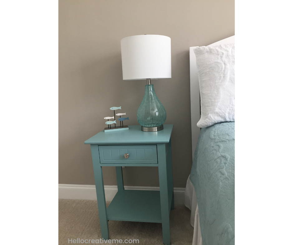 small teal DIY painted nightstand with lamp on top