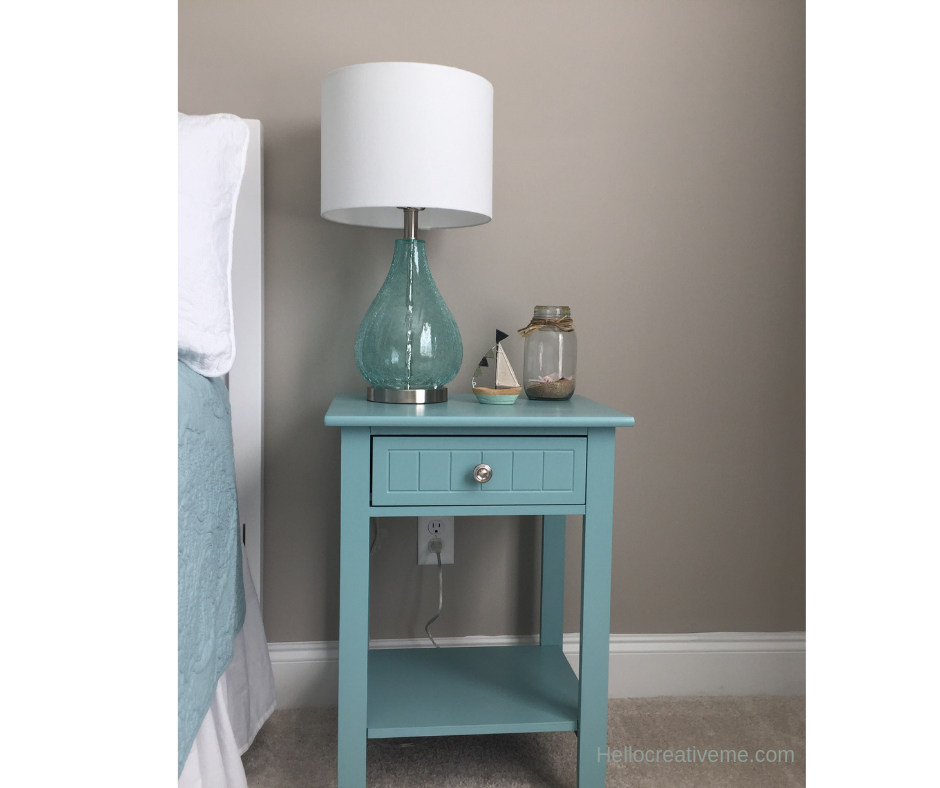 lamp and decor on top of painted nightstand