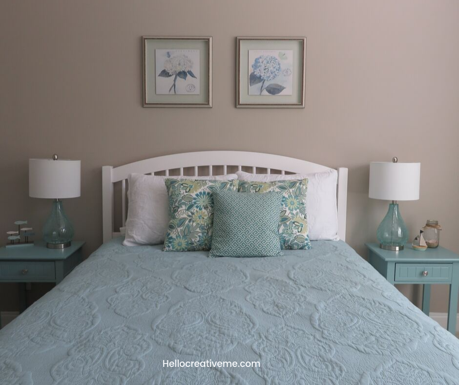 queen bed with aqua quilt and teal patterned pillows