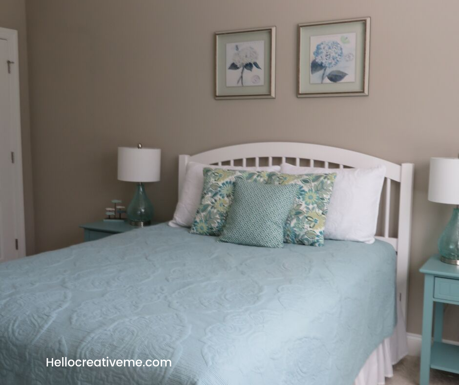 queen size bed in room with 2 hydrangea pictures above it