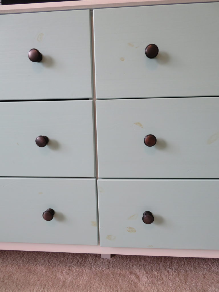 Closeup of IKEA Tarva dresser painted drawers with pine knots showing through