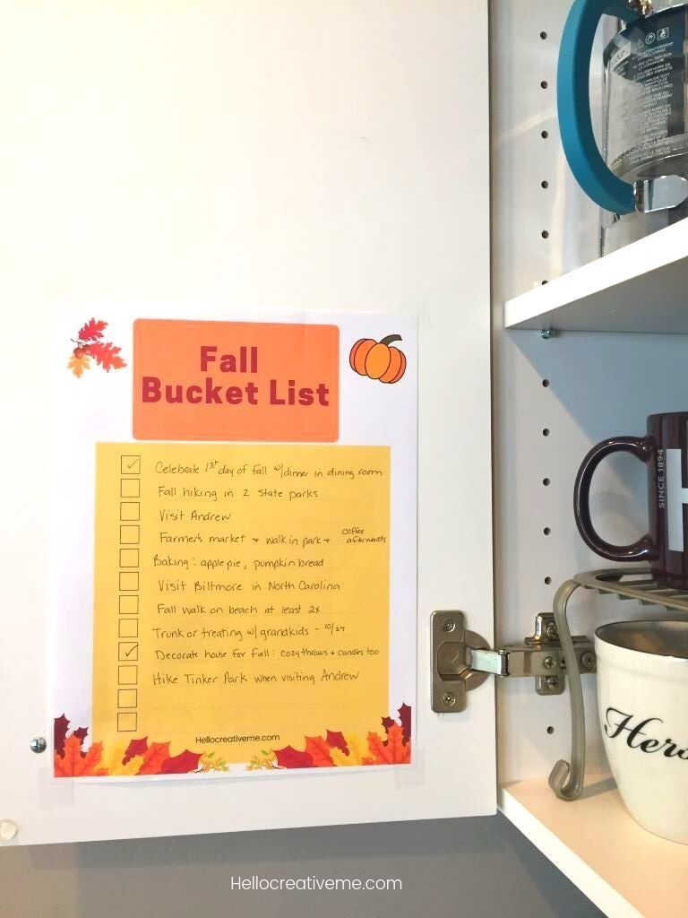 fall bucket list taped on inside of cabinet door
