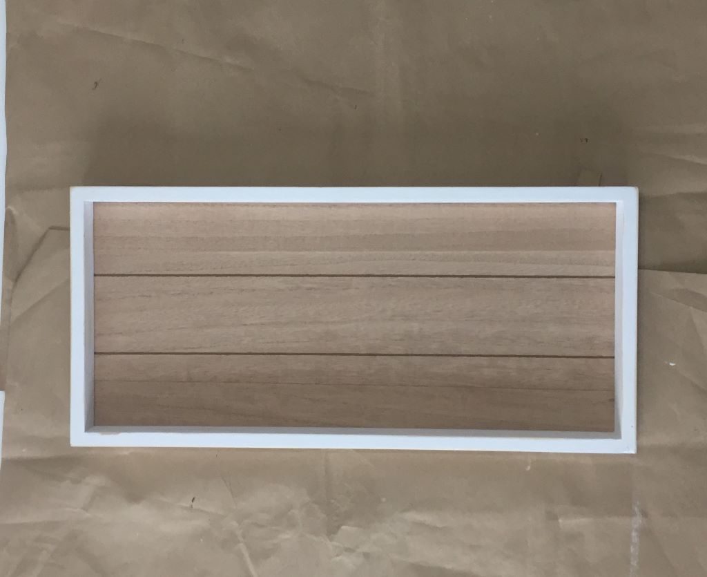 white rectangular frame with wood background