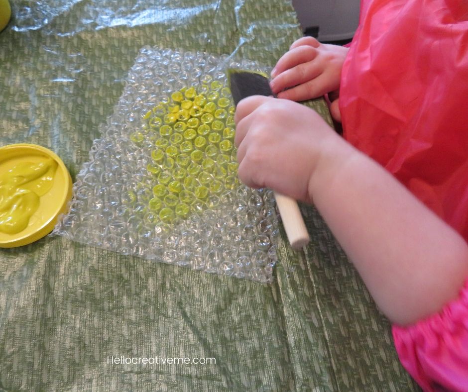 child painting on bubble wrap