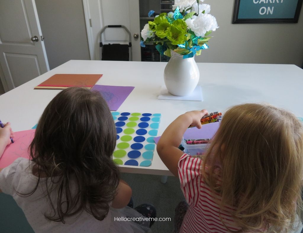 two girls sitting at DIY craft room table