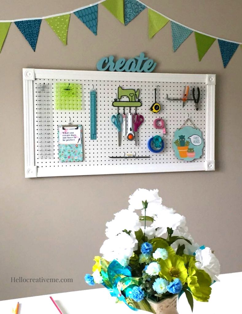 DIY framed craft room pegboard with tools on it.