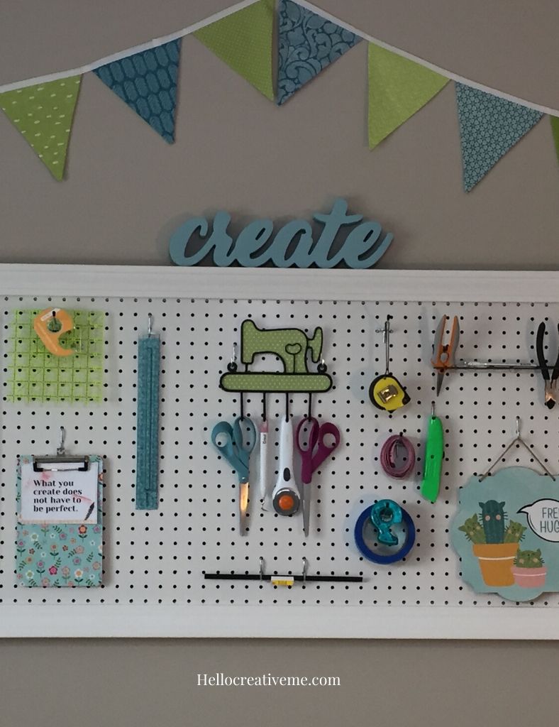 white pegboard with tools on it