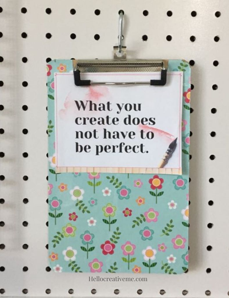 small floral clipboard on pegboard