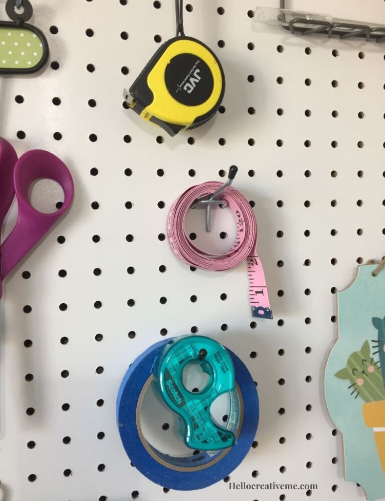tape and tape measures hanging on pegboard