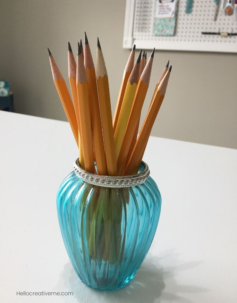 yellow sharpened pencils in aqua vase