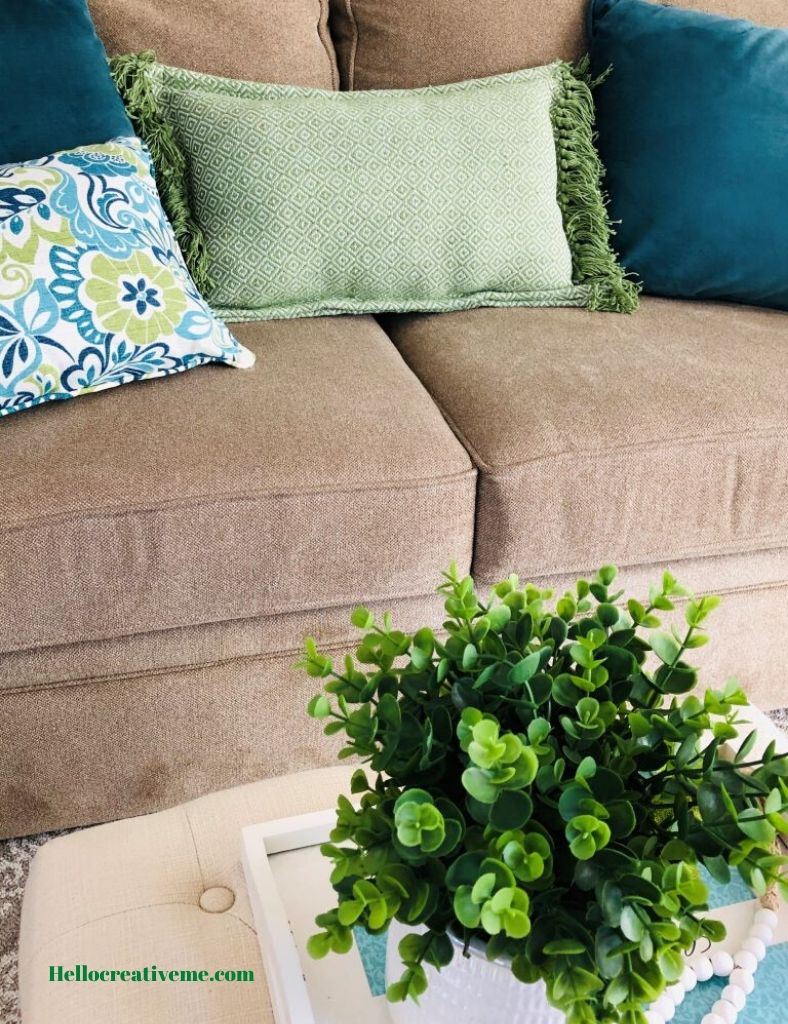 green DIY pillow on tan couch