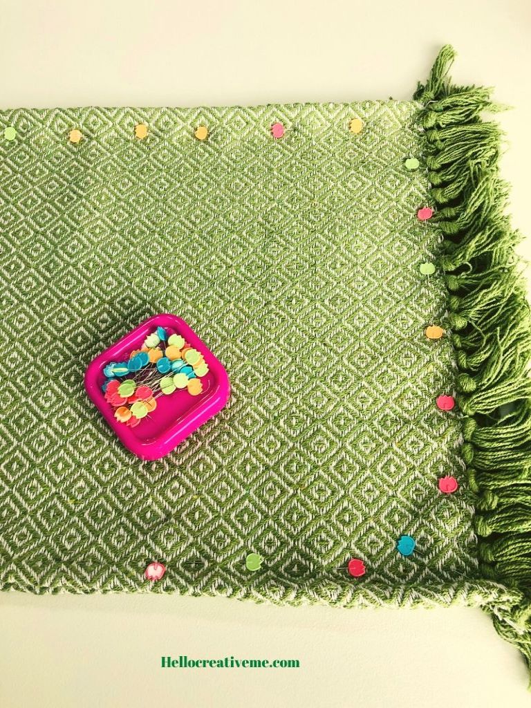 green throw rugs pinned on edges
