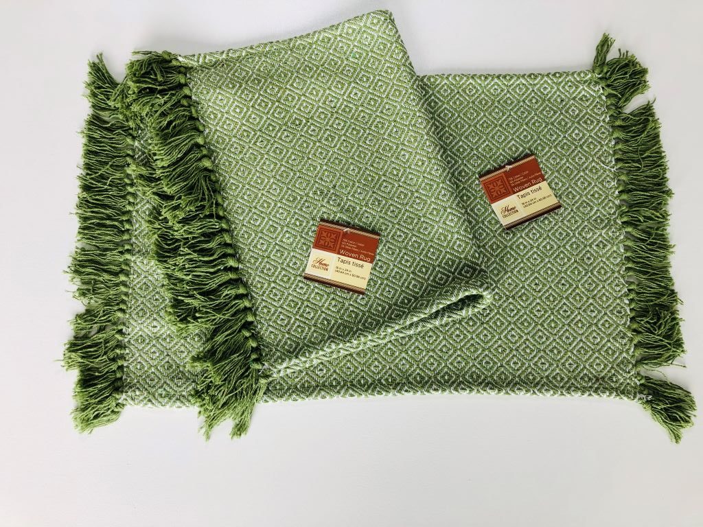 two small green throw rugs with fringe