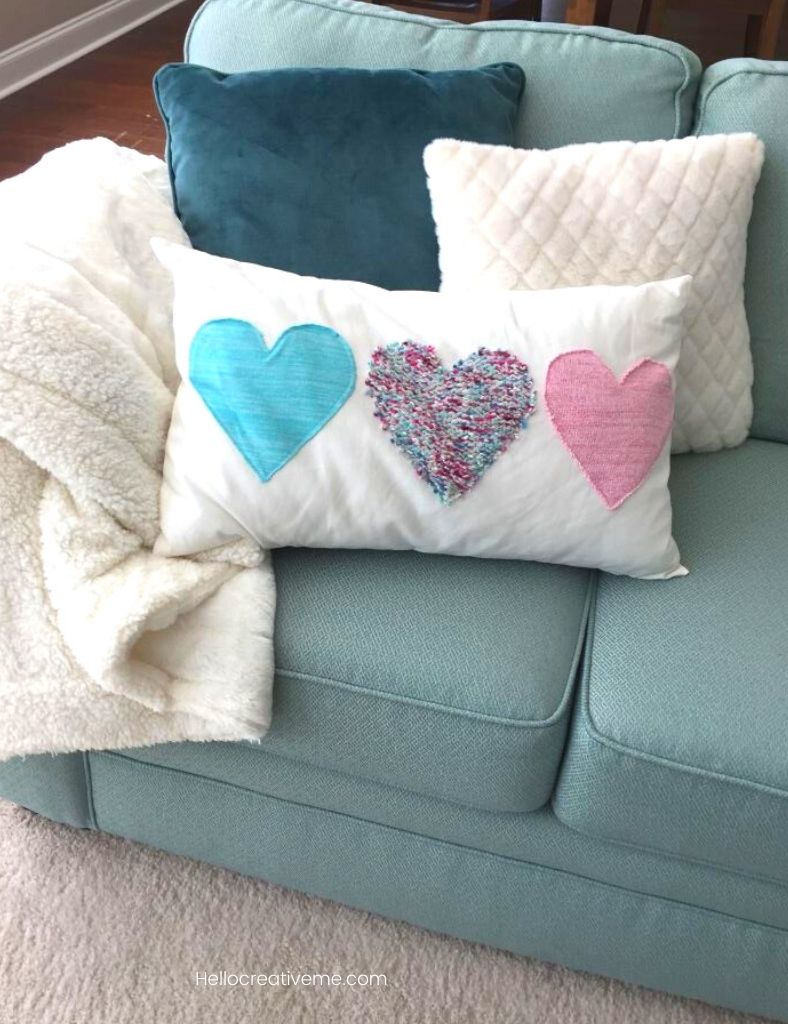 Valentine heart pillow grouping on aqua couch