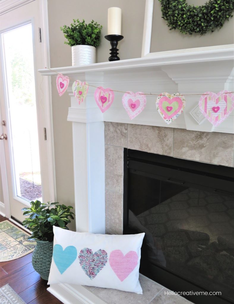 paper heart banner hanging on fireplace