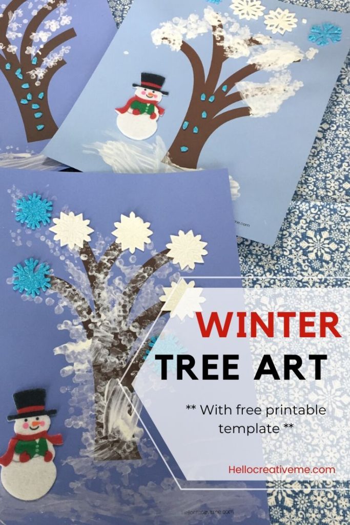 bare trees painted with white "snow" and adorned with snowman and snowflake stickers.