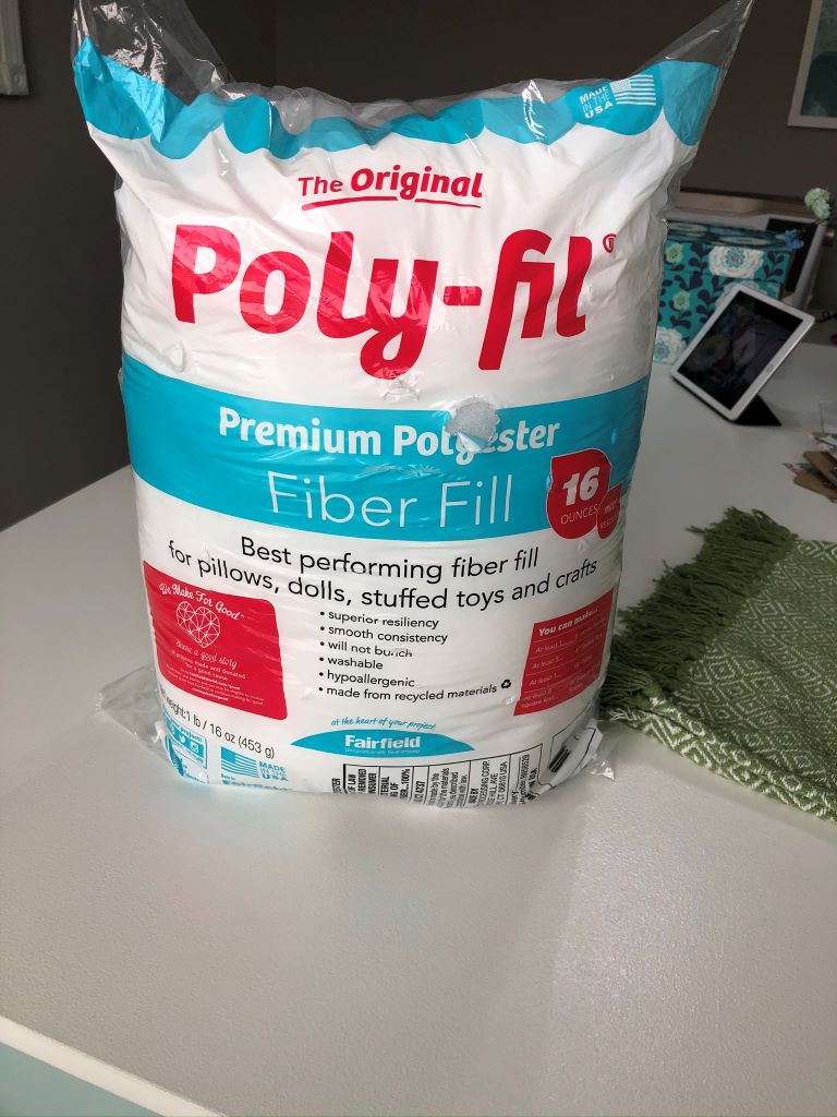a bag of fiberfill for stuffing inside of a DIY Throw Rug Pillow