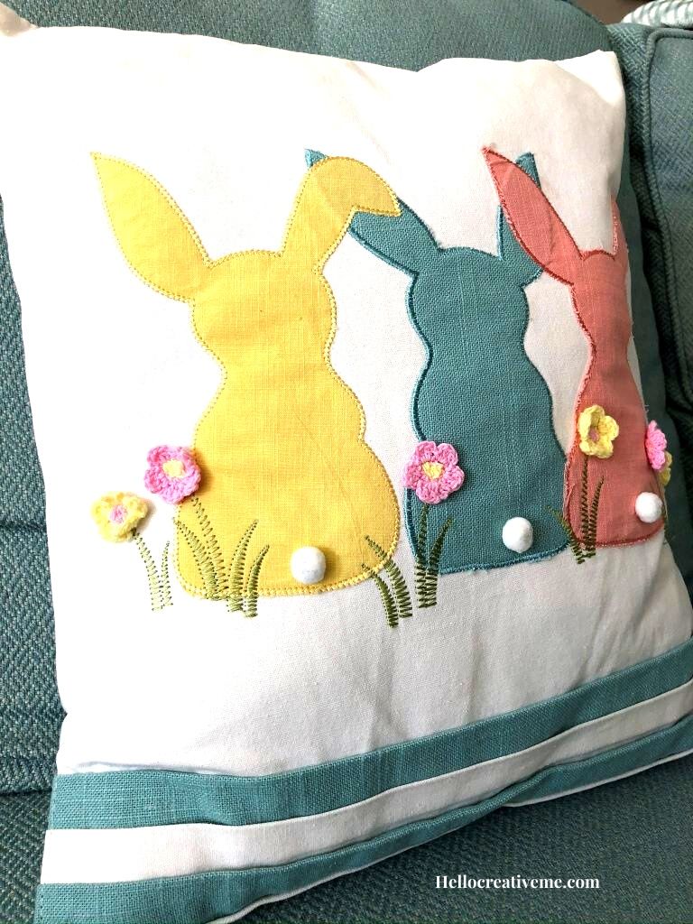 3 bunnies on a white pillow