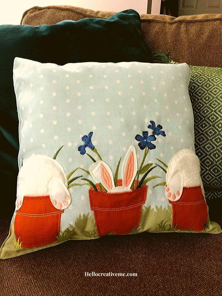 bunnies in flowerpots on a pillow made from a table runner