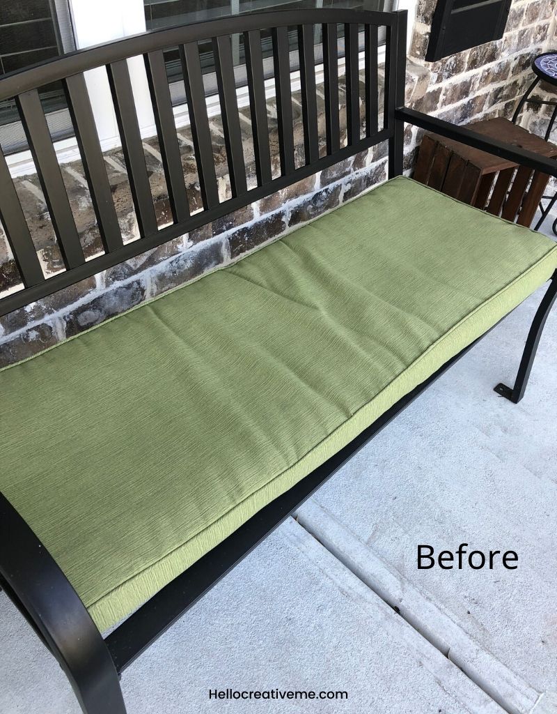 Spring porch refresh before picture with boring bench with green cushion on porch