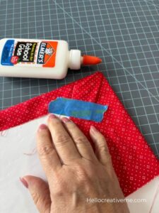 The back side of a fabric wrapped foam core board secured with glue and tape.