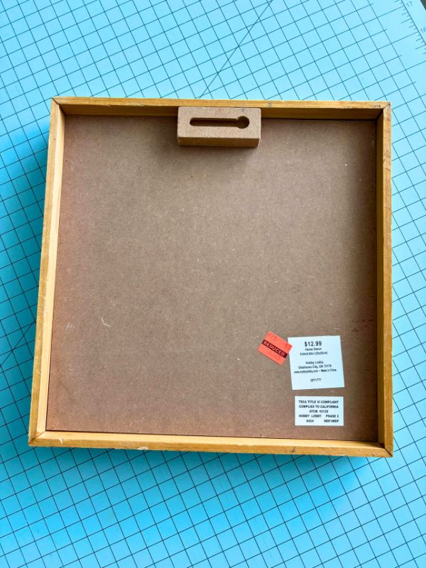 Back of frame with attached hanger, ready to hang on wall.