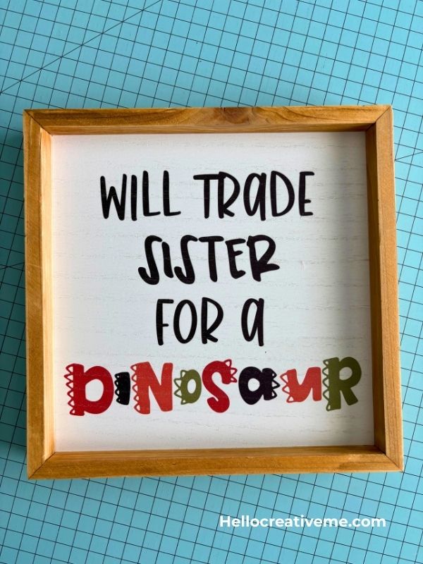 Framed print with text that reads will trade sister for a dinosaur.