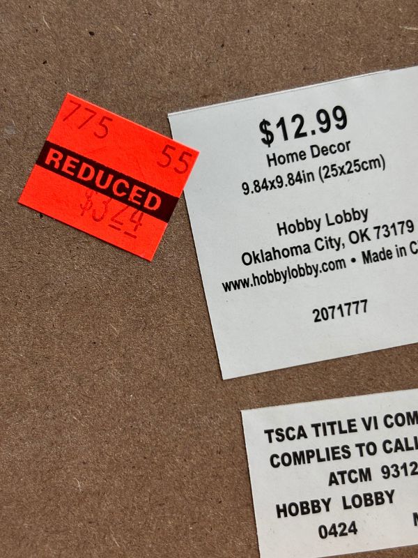 Close up of labels showing reduced price and original price tag of frame.